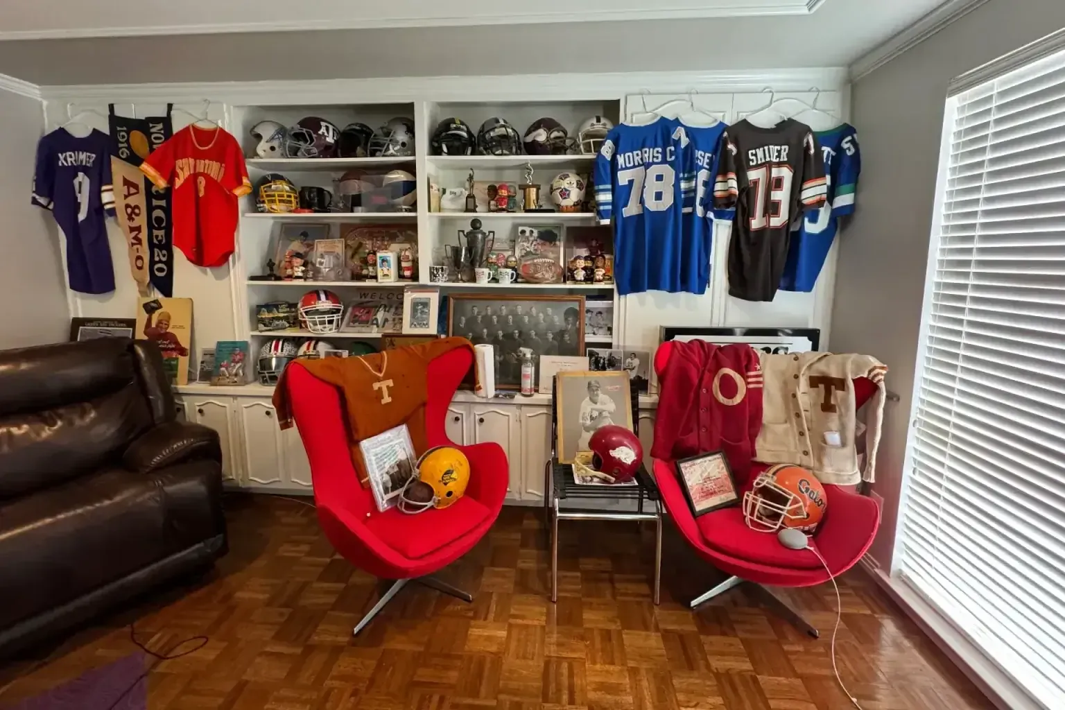 Estate sale sports memorabilia — a craftsperson working the top of a tall run of finished work