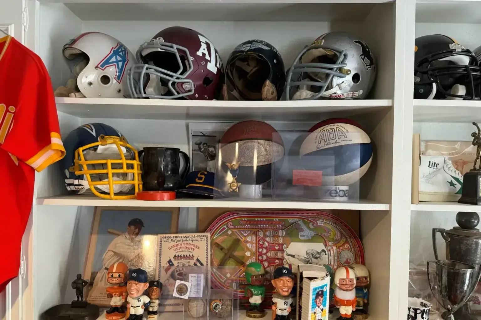 Sell signed baseballs — a craftsperson sighting along the finished work to check it is true