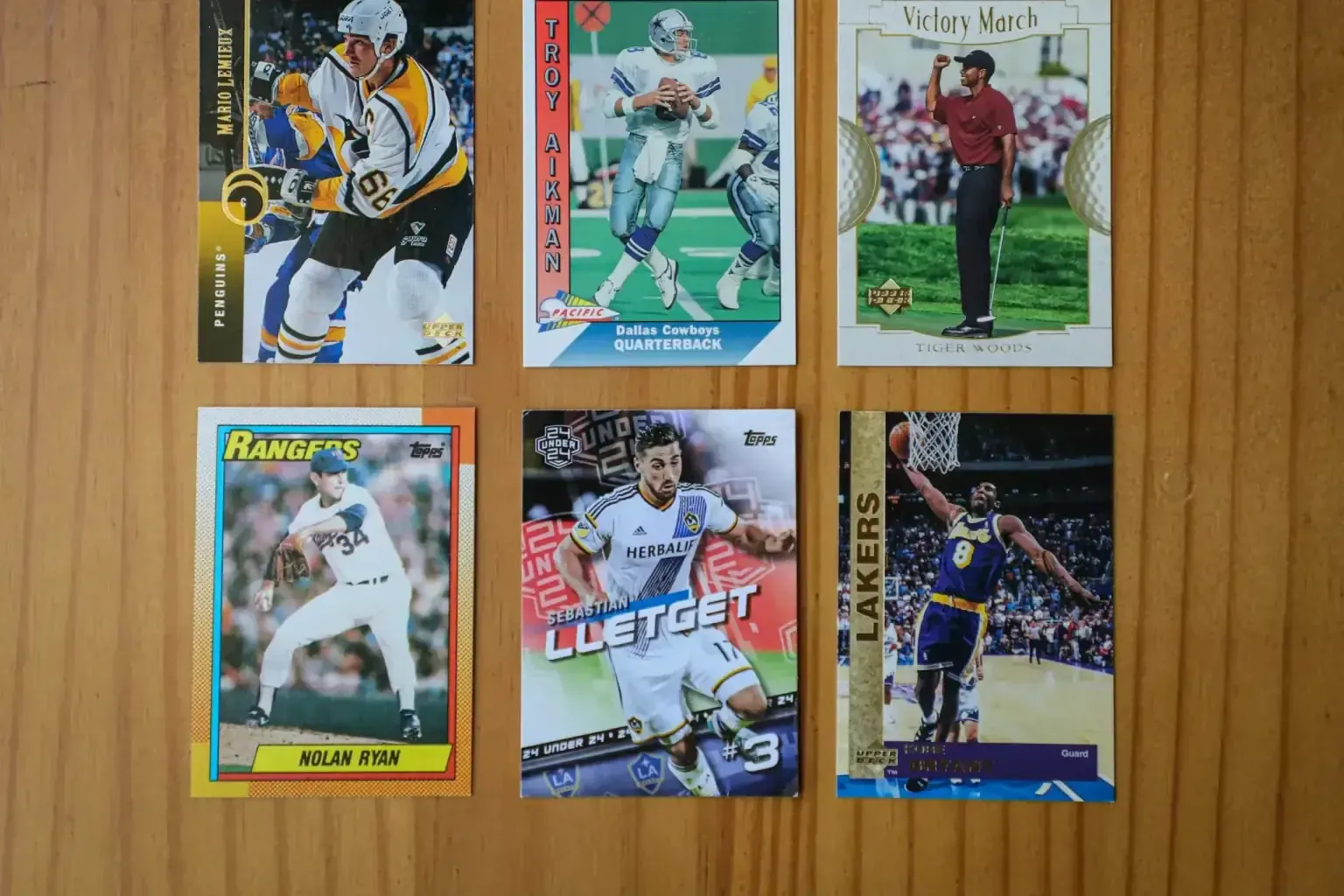 Vintage baseball card collection — a craftsperson working the top of a tall run of finished work