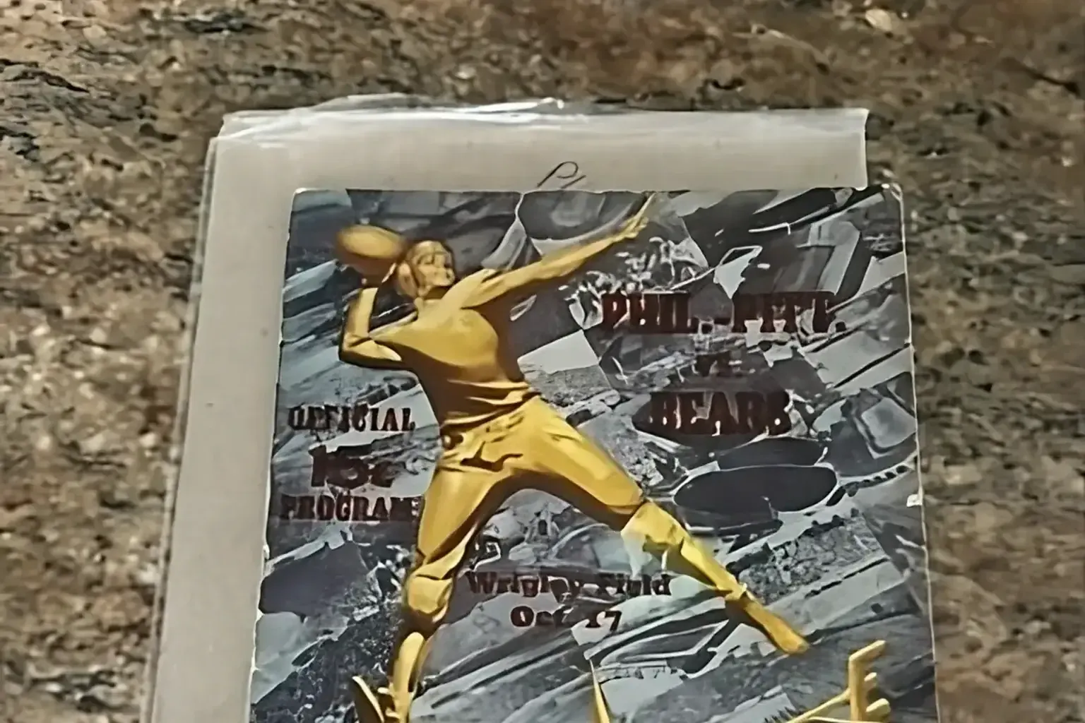 Sell vintage sports programs — a craftsperson working the top of a tall run of finished work